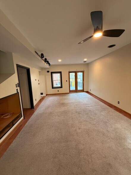 Huge entry living space with door to back yard and windows on both sides of the room. Sunny & open! - 327 Hudson Ave