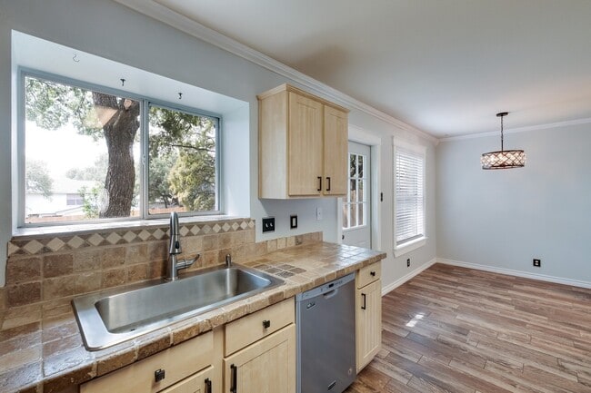 Building Photo - ***APPLICATION CURRENTLY UNDER REVIEW***Modern Elegance: 3-Bedroom Townhome with Wood Flooring, S...