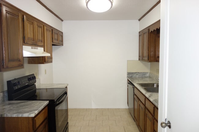 Kitchen with New granite tops, ample cabinets, Double basin sink, and radiant range - 6604 S Utica Pl