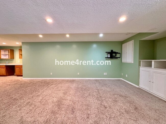 Building Photo - Beautiful Four-Bedroom Home with Three Car Garage, Wood Floors, Finished Basement and a Fenced Ya...