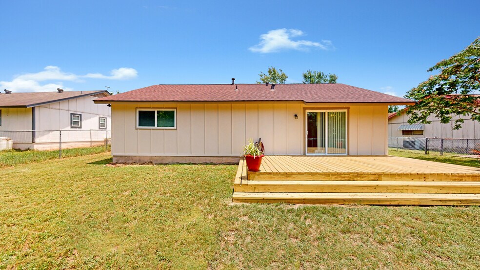 Back of house featuring a wooden deck - 5906 Wagon Bnd
