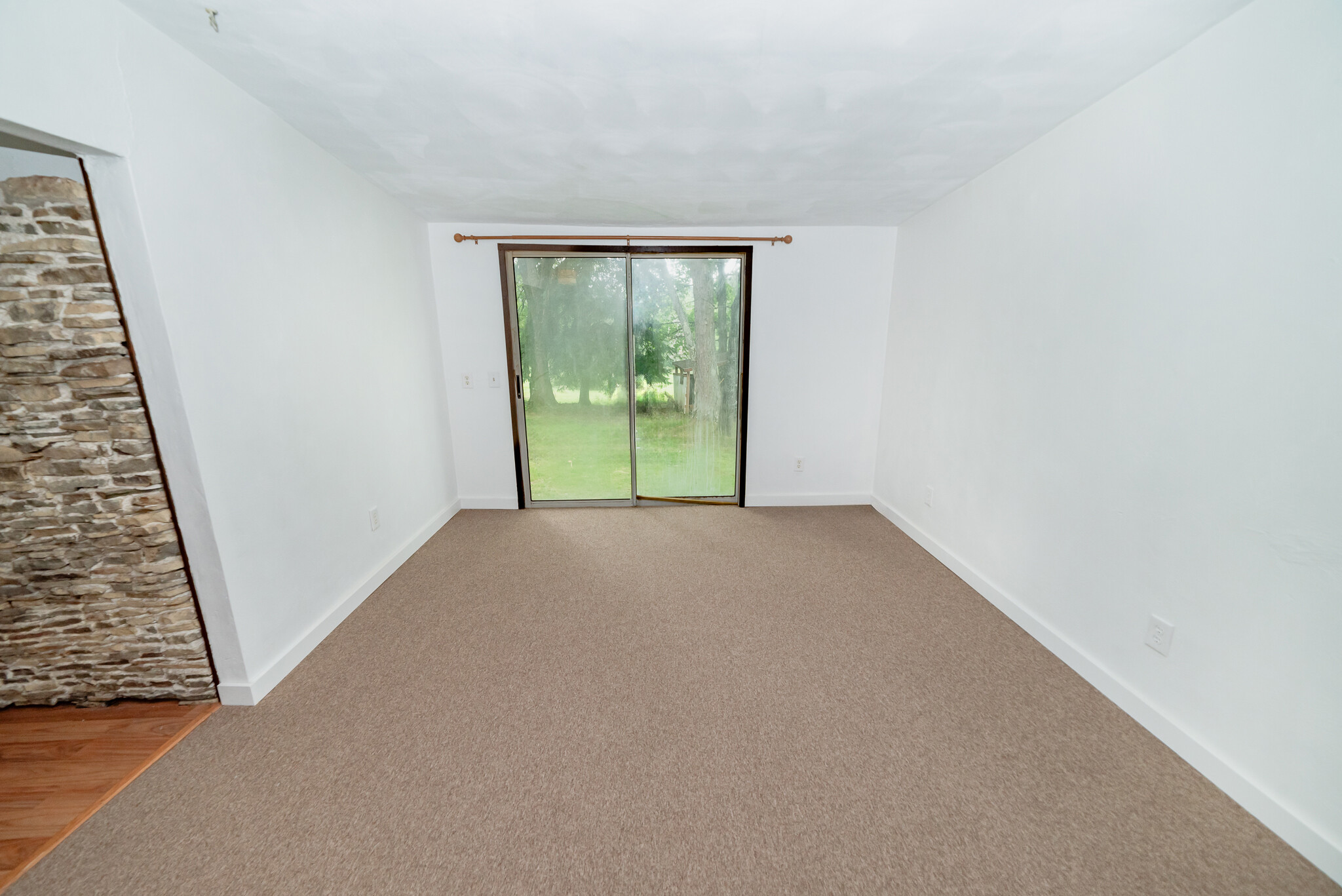 Living room with screen door to backyard - 22 Muckey Rd