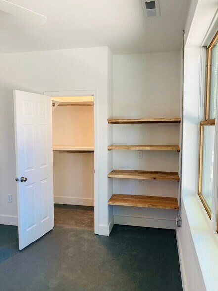 Walk-in Closet with Double Clothes Rods in Primary Bedroom - 1311 Blair St