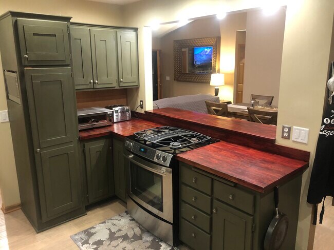 Kitchen look through to dining room and living room - 11022 Quebec Ave N