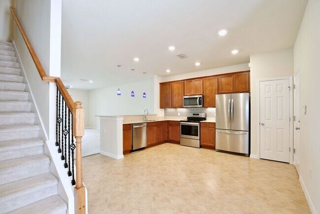 Building Photo - Immaculate Townhome · Dual En-Suite Bedrooms + Flex Loft · Cable & Internet Included · 3.5 Miles ...