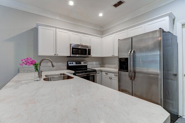 Building Photo - Gated Tampa Palms Townhome with 2-Car Garage, Screened Lanai & Community Pool