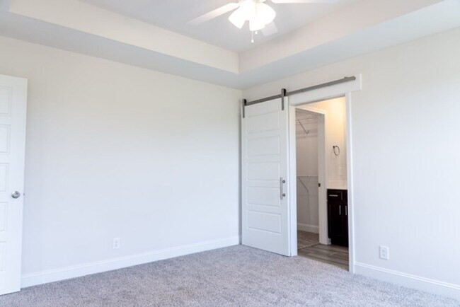 Building Photo - Modern Living Redefined with Stone Fireplace, Gray Cabinetry, Spa Inspired Primary Suite and Cove...