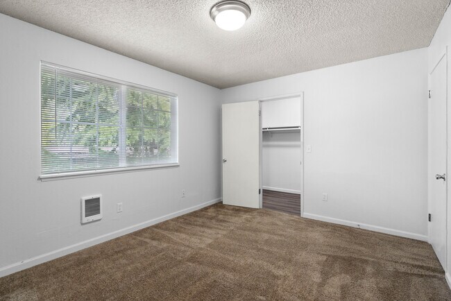 Experience comfort and style in this bright, spacious bedroom. - University Crossing Apartments