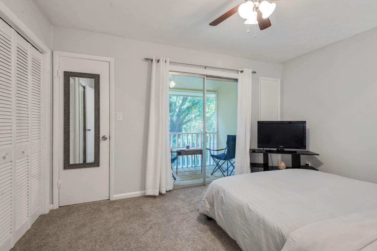 Masterbedroom with balcony that overlooks private back yard space - 4783 Dick Mitchell Dr
