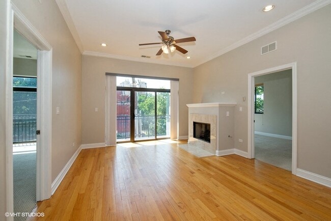 Living room with a ceiling fan and a fireplace - 2 Bedroom - 4651 N Greenview