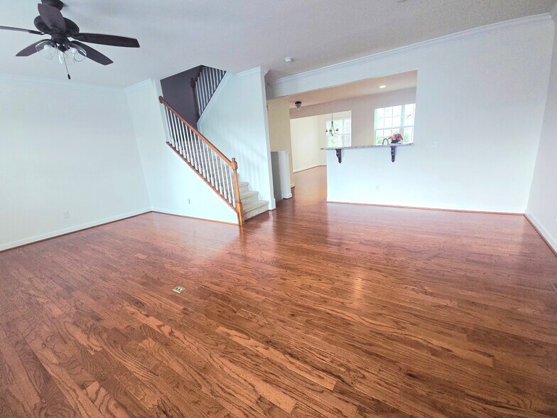 Living room with a view to the kitchen and formal dining area - 1207 Heritage Links Dr