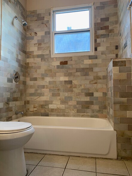 Textured mosaic tiles in common bath - 69 Schley St