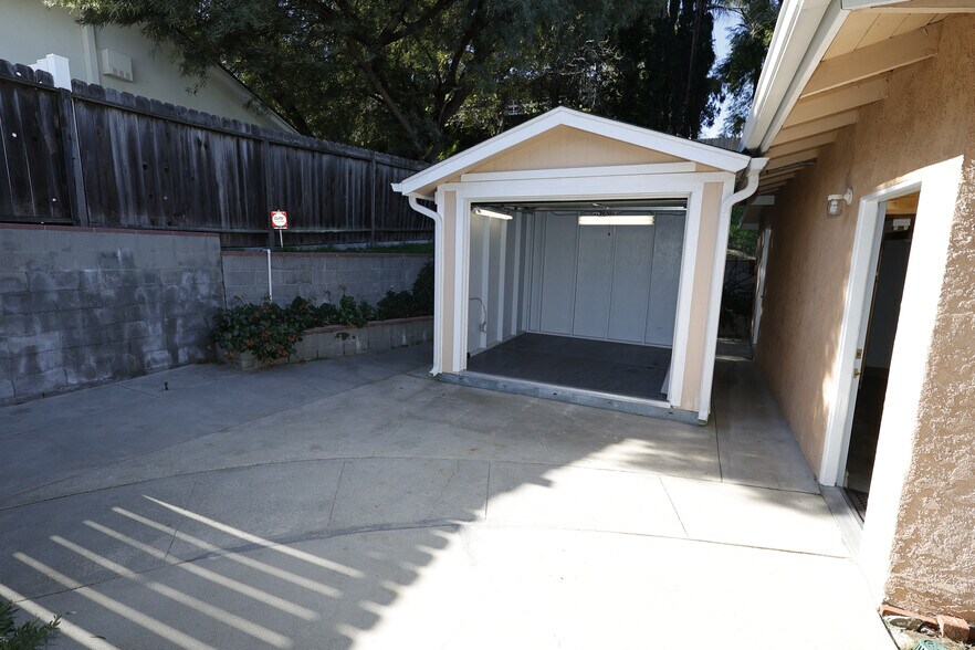 Extra workshop or storage shed with remote controlled retractable garage door. - 4831 Canoga Ave