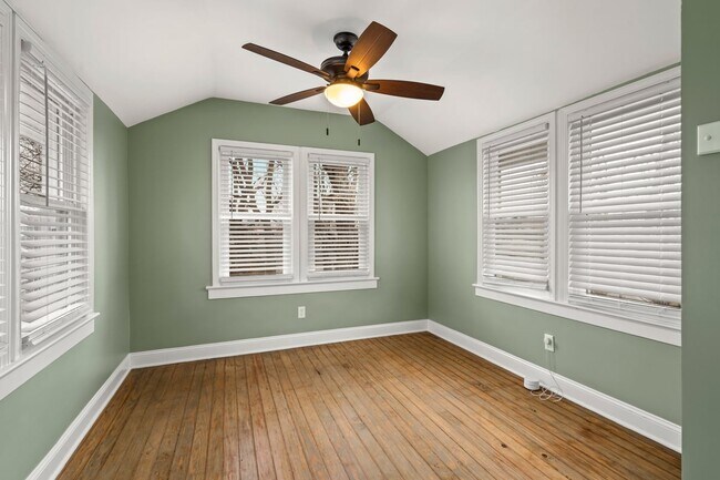 Bedroom #3 upstairs with vaulted ceilings, plenty of natural light and view of spacious backyard - 4517 Tracy Ave