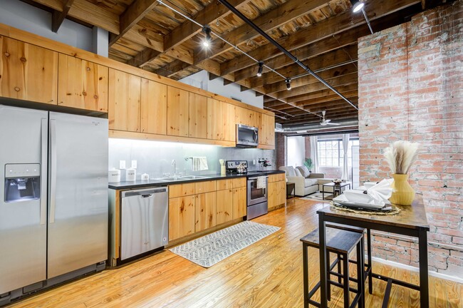 Renovated Lofts with exposed steel beams and brick accents - Mitchell Lofts