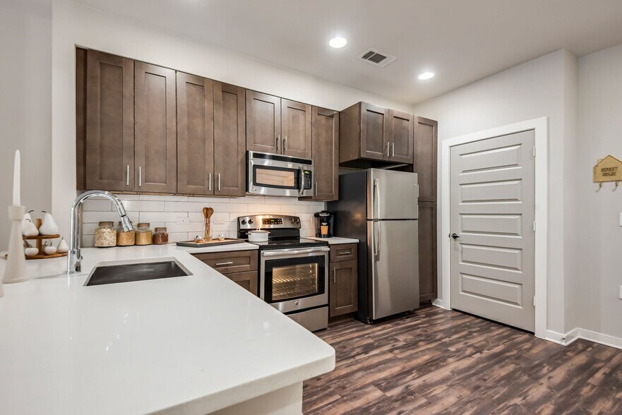 Spacious Kitchen with Sleek Cabinetry and Stainless Steel Finishes - Lamar Union