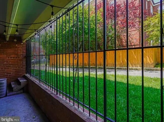 Private patio with secure door opens onto more lawn space and private parking lot - 1384 Bryant St NE
