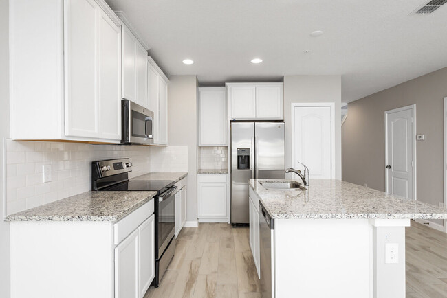 Bright, open kitchen with quartz countertops - 14799 Outfitter St