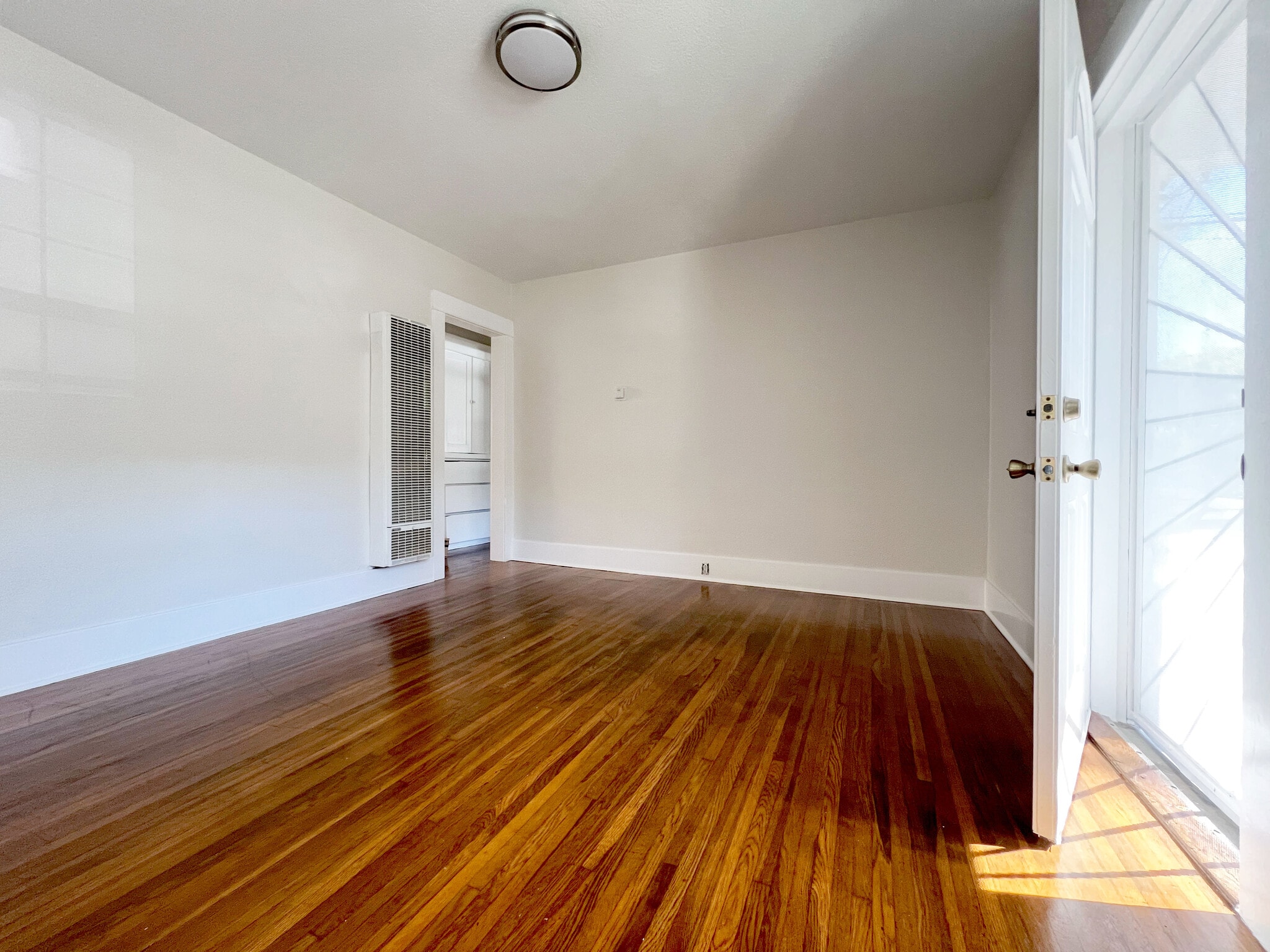 Spacious living room with natural light. - 1817 E 8th St