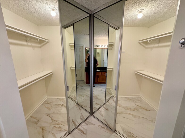 large walk-in closet with double, full-length, mirrored doors - 209 14th St. NE #119