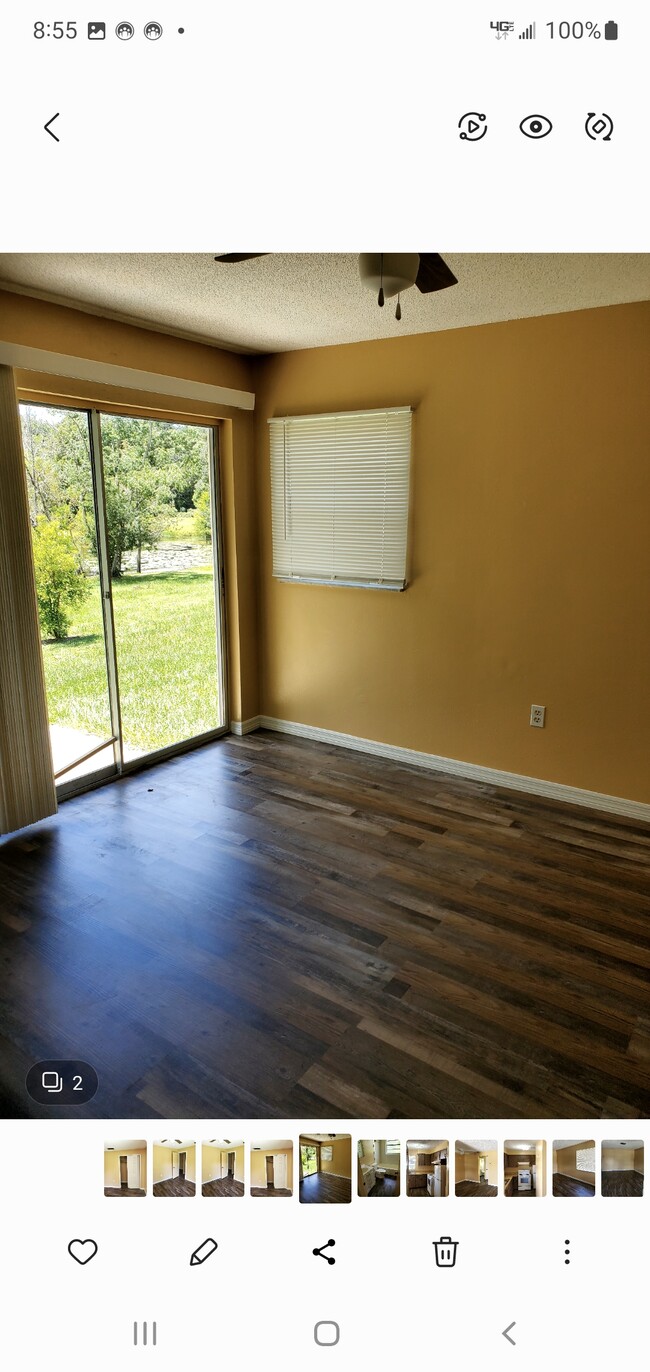 Master bedroom with sliding doorwall overlooking small lake - 6534 West Norvell Bryant Highway