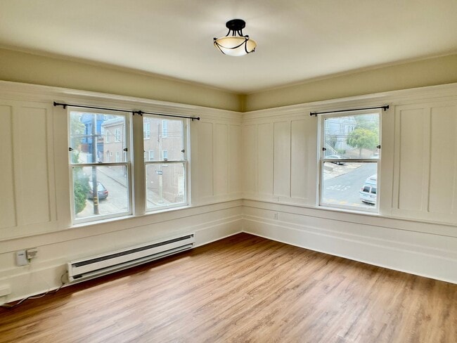 Building Photo - TOP FLOOR, Corner Studio. Hardwood Floors!...