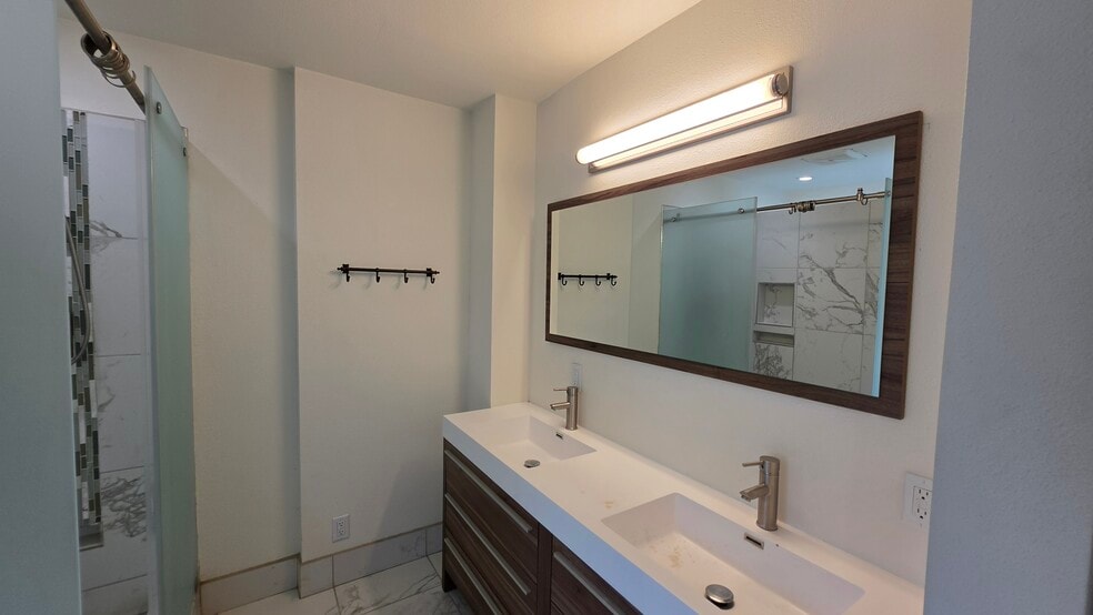 Large primary bathroom with double sinks and spacious shower. - 3078 Saddleback Ct