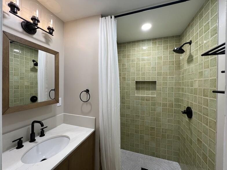 The second bathroom with a custom tile shower. - 2824 S Orange Dr