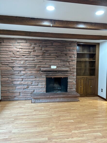 Book shelf next to fire place - 435 E Drake Rd