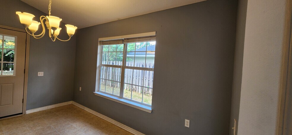 Kitchen nook with a double window view of back yard, beautiful morning sunshine shines here - 2318 Tall Oak Dr