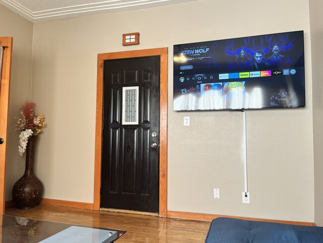 Another view of front entry door, with 65" smart TV in full view - 3517 19th Ave S