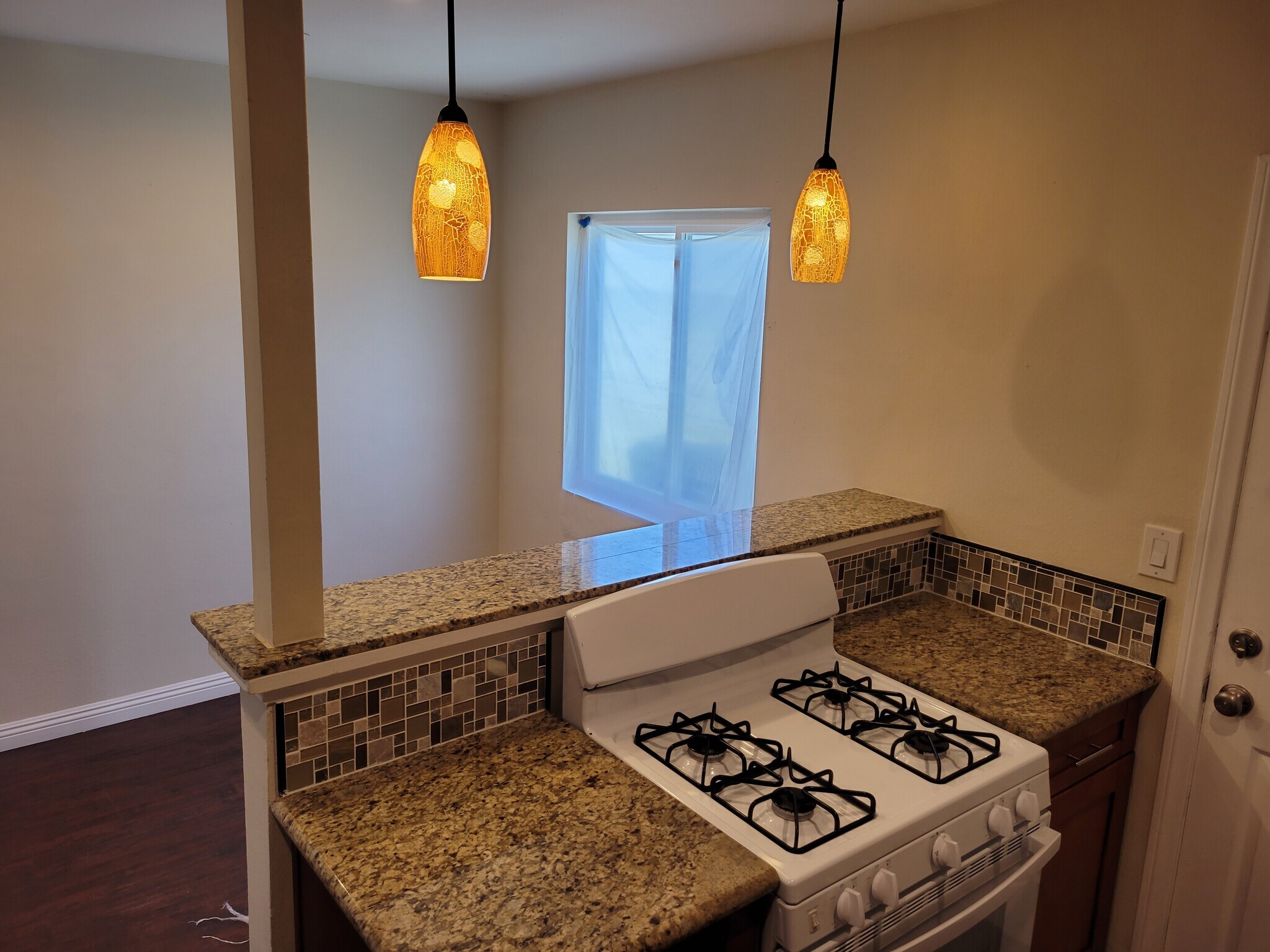 VIew of Stove with dining area on other side - 14028 Doty Ave