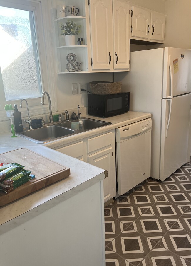 Kitchen windows face backyard and deck - 141 Lagrange St