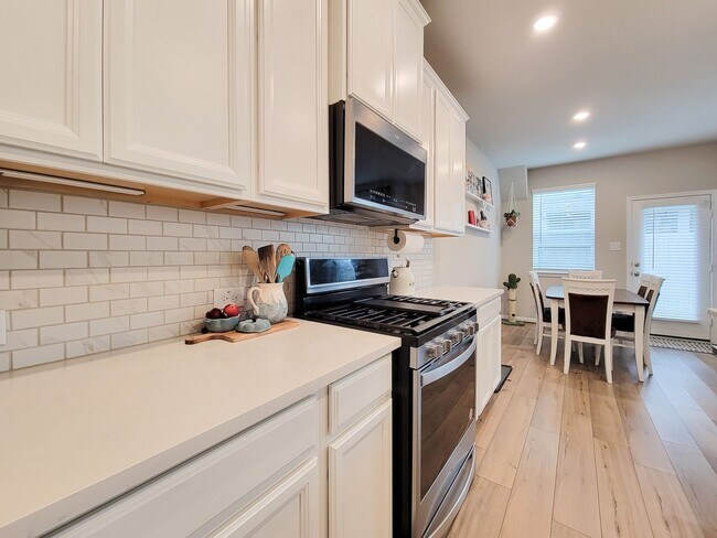 Building Photo - A true gem on a quiet corner lot, this spacious and sun-filled home is tucked away from street no...