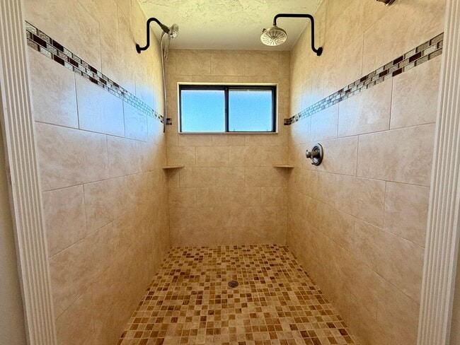 Building Photo - Light-Filled 2BR Condo in Gated Pelican Bay Near Golf, Beach & I-95