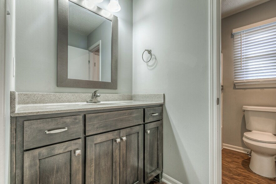 1st-floor master bathroom with shower/tub combo. separate area for vanity/sink. - 13749 W 62nd St