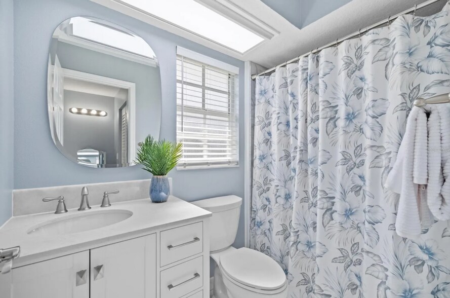 Bright ensuite bathroom with large vanity and updated fixtures. - 1932 Brainerd Ct