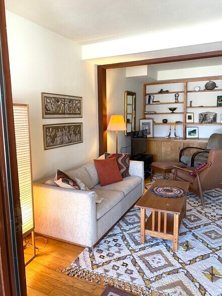 Living room sofa with built in bookshelves - 206 Hanshaw Rd