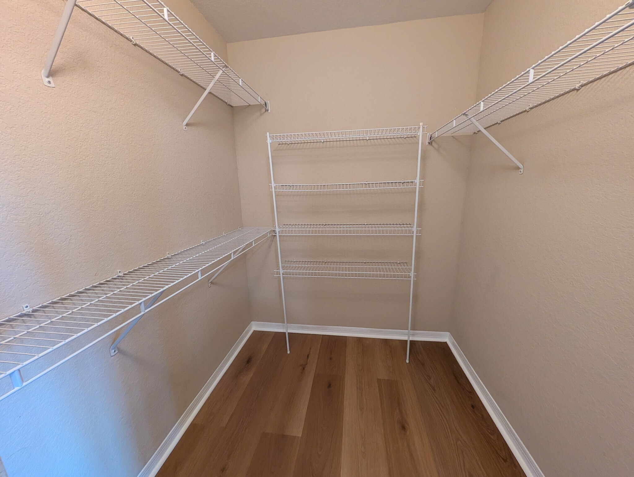 Primary bedroom walk in closet - 5218 Hampton Beach Pl