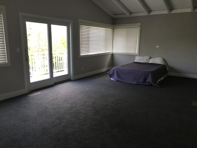 Master bedroom upstairs opening up to a deck overlooking the back yard - 506 Anderson St
