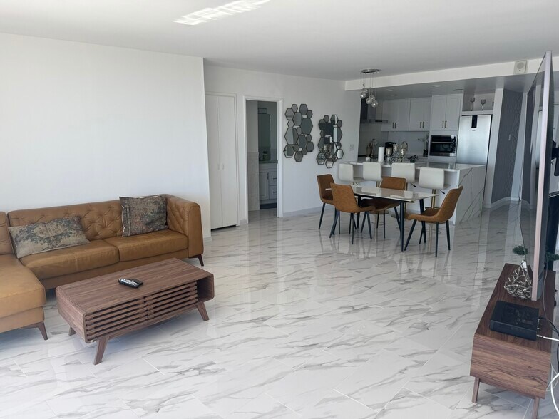 Cozy modern living and dinning room with natural lighting. - 700 E Ocean Blvd
