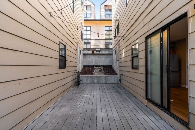 Building Photo - Modern 2BD, 1.5BA Condo with 20' Ceilings and Garage Parking Spot