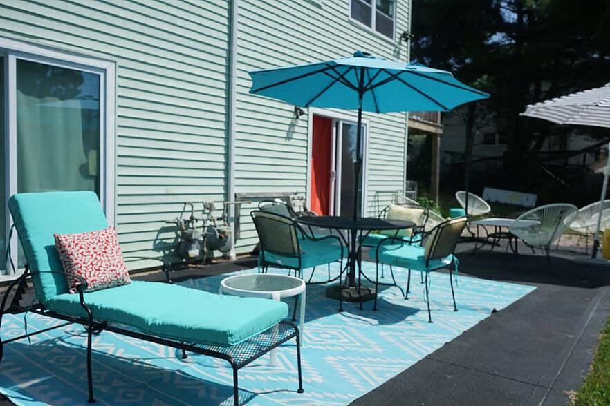 Backyard patio equipped with tables, umbrellas, grill, outdoor pizza oven, fire pit & loungers, etc - 15 Brandywine Dr