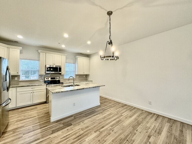 Building Photo - Practically New & Available NOW! Americana Luxury Townhomes! Pet Friendly! Attached Garage! All A...