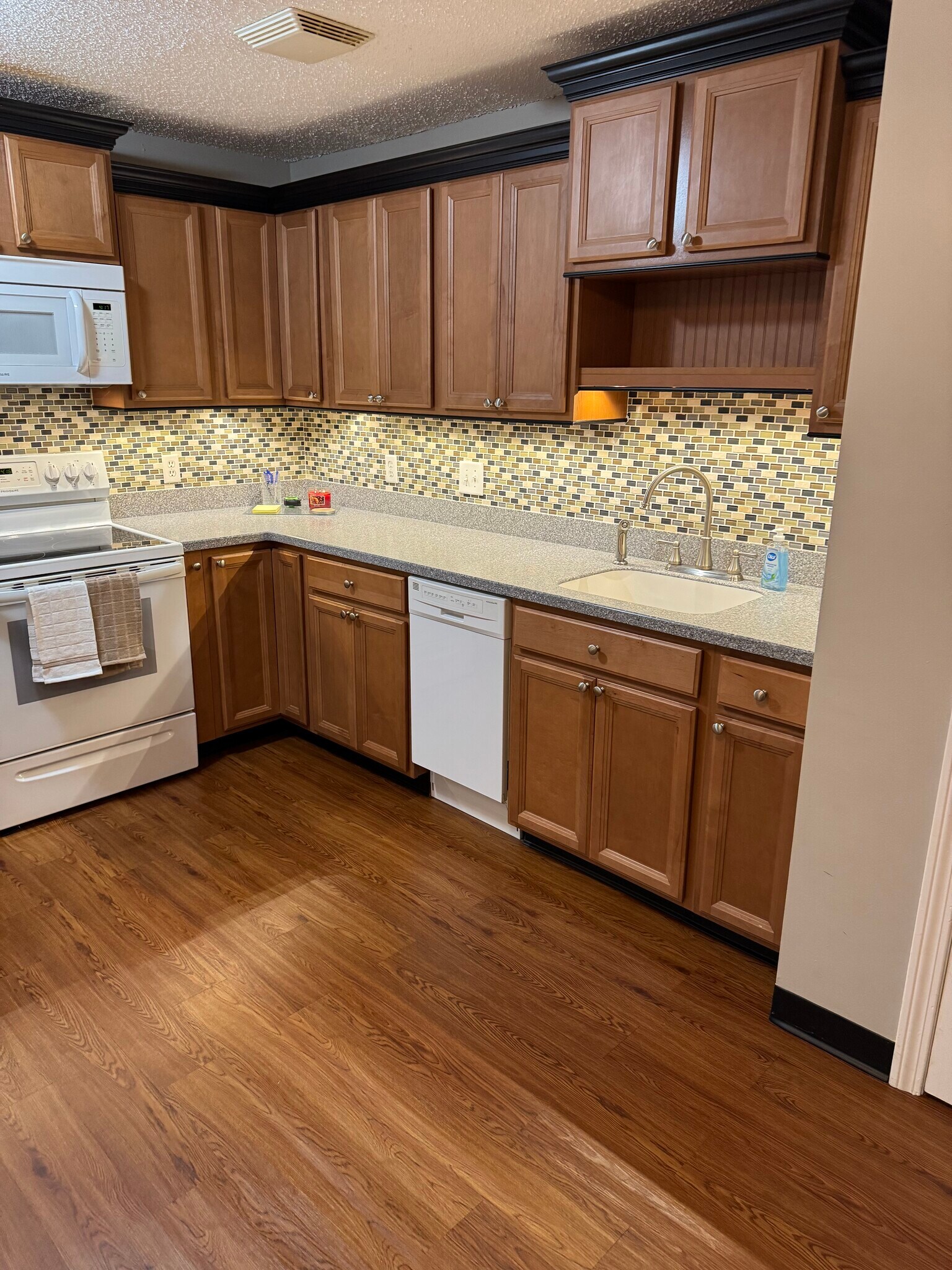Custom kitchen with glass tile backsplash, solid surface counters and integrated sink - 9 Northbrook Dr