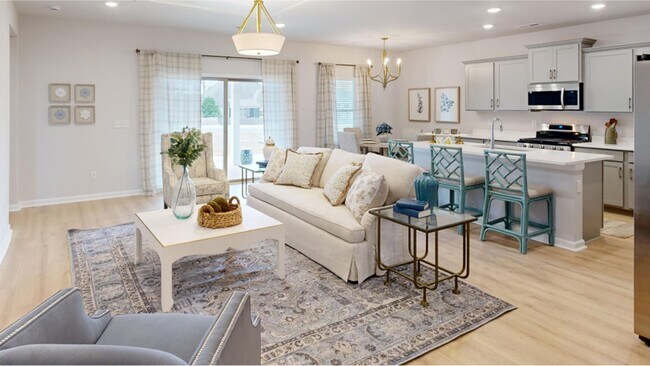 An airy, open-plan layout connects the Great Room, the kitchen, café and the adjacent covered porch - 15580 Ruthie Lynn Dr