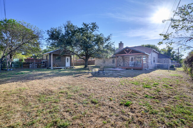 View of yard with a patio area. Dog run to the right. - 209 Prairie Wind Blvd