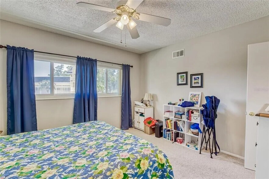 Guest bedroom with ceiling fan and closet space [Unit is unfurnished] - 2460 Franciscan Dr