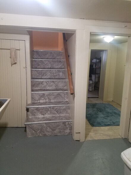 Bottom stairs and bathroom to right - 521 Harrison St