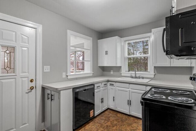 Building Photo - Brick home, Two Story, Hardwoods, DR, 2 Sun Rooms, FP, Carport!.